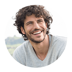 Young man smiling outside